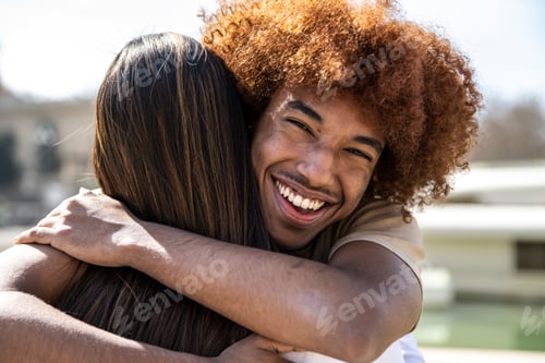 Preview: Close up of a young happy man hugging a woman with straight hair. Lovely guy smiling while embracing