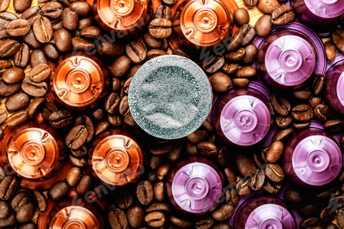 Preview: Espresso coffee capsules or pods and coffee beans on wooden rustic background
