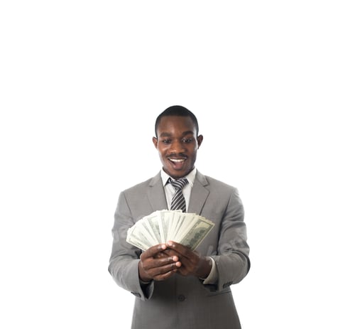 Preview: African-American businessman holding money and showing to camera isolated on white.