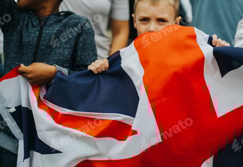 Preview: Group of diverse kids showing a UK flag in a protest