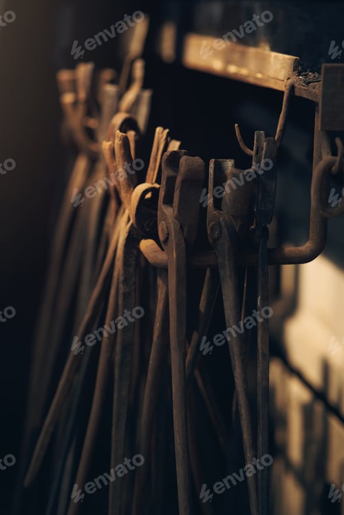 Preview: Rusty Forging Tongs Hanging in a Workshop