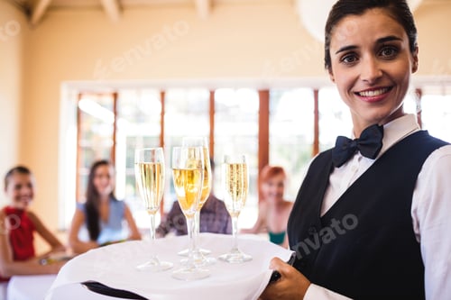 Preview: Waitress champagne glasses on tray in restaurant