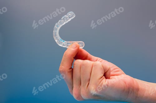 Preview: Dental aligner used by dental doctors isolated on blue background.