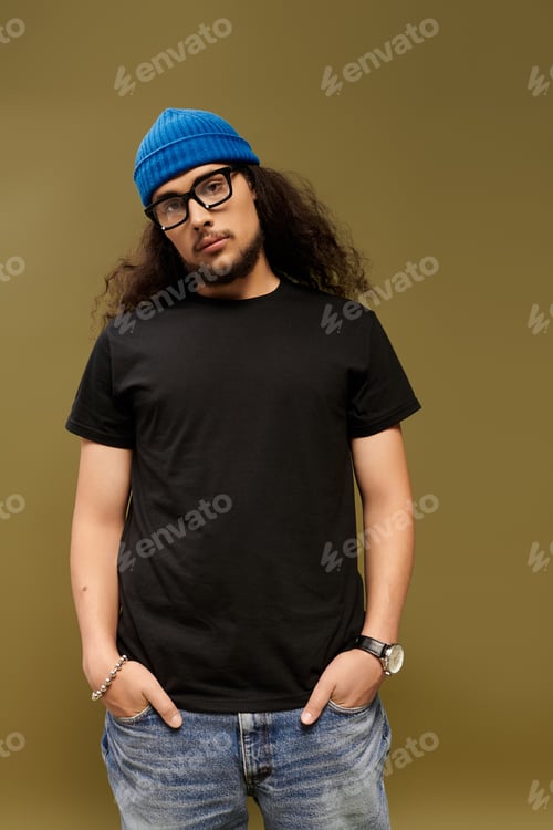 Preview: Charming young man with beard poses confidently in stylish casual wear against a warm backdrop