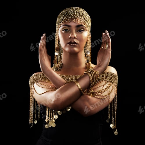 Preview: Portrait of an attractive and elegantly dressed young woman posing against a dark background
