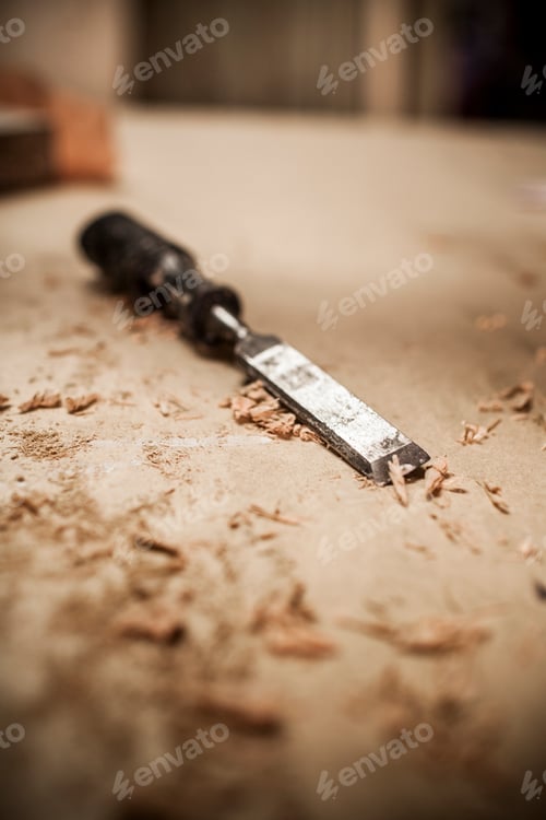 Preview: Close-up of chisel and shavings on wood