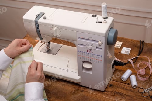 Preview: Sewing machine used by woman hands
