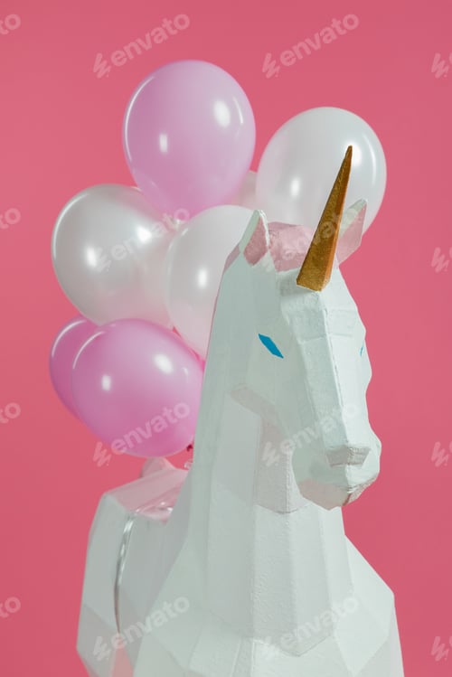 Preview: Paper unicorn with decorative air balloons isolated on pink