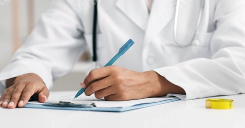 Preview: Cropped of african female doctor dietologist filling medical chart