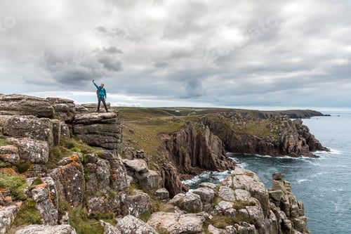 Preview: Man taking a selfie on a rock cliff enjoying the view