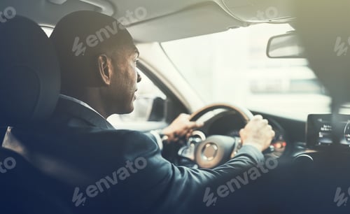 Preview: Young African businessman commuting to work in his car