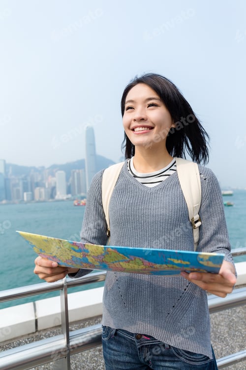 Preview: Woman looking for paper map in Hong Kong