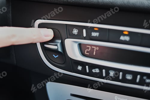 Preview: Woman hand set the temperature on air conditioner panel in car. Climate control panel