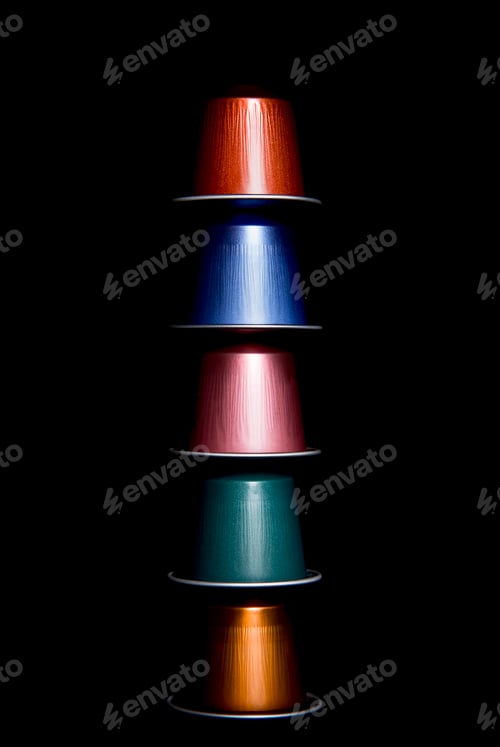 Preview: close up of a group of colored coffee capsules arranged on top of each other