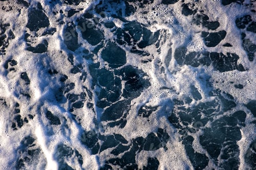 Preview: Top down aerial view of sea water surface. White foam waves texture as natural background
