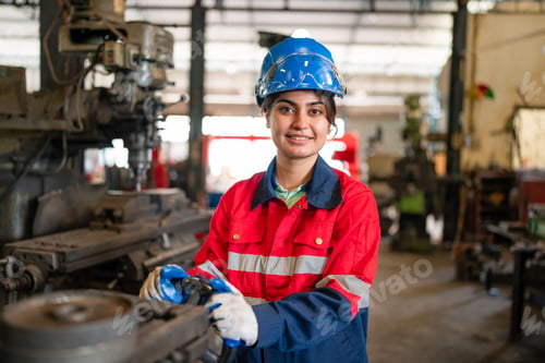 Preview: Portrait of female automation engineer standing in modern industrial factory.