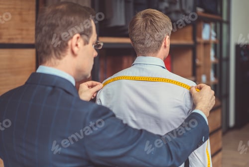 Preview: Bespoke Tailor Measures Client for Custom Fitted Suit