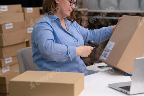 Preview: female entrepreneur running small business, packing an online order for express delivery