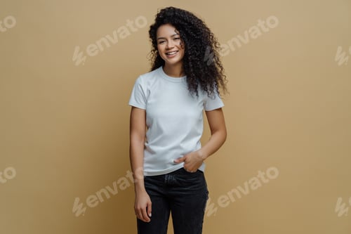 Preview: Photo of slim cheerful African American woman with curly hair, smiles happily