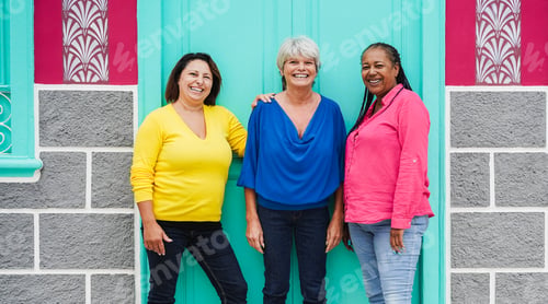Preview: Multiracial senior women having fun hugging together outdoor