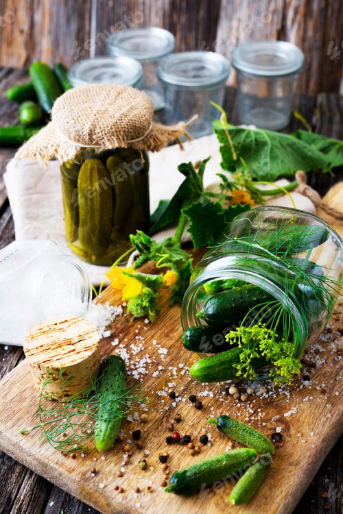 Preview: Jars of pickled marinated cucumbers on rustic table