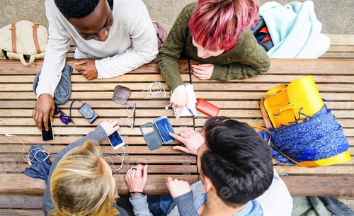Preview: Top view of multiracial friends using mobile smart phone