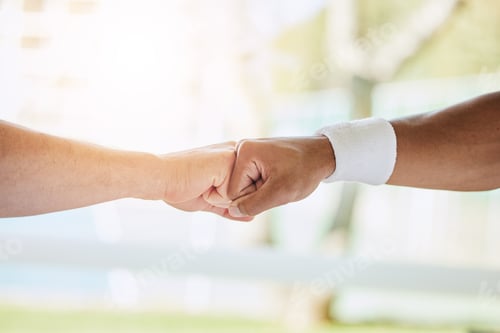 Preview: Cropped shot of an unrecognizable male tennis player and his coach fist bumping in the clubhouse
