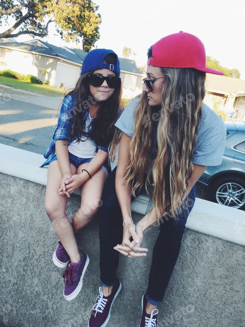 Preview: Girl and Woman Sitting in Suburban Setting
