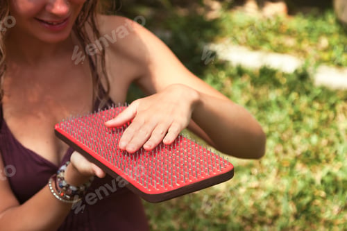 Preview: Young Woman Exploring Mindfulness Through Yoga Practice on a Sadhu Board in Nature