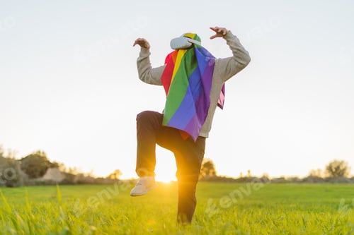 Preview: Person with VR Headset and Rainbow Flag Dancing Outdoors