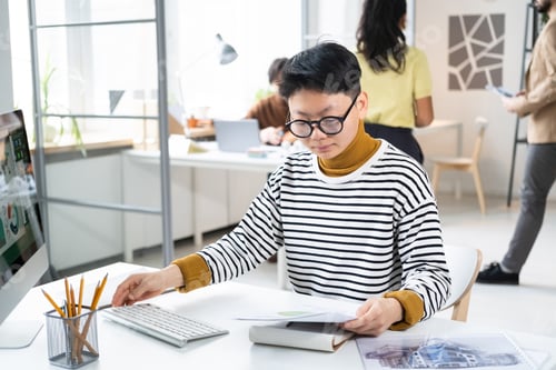 Preview: Businesswoman doing paperwork at office