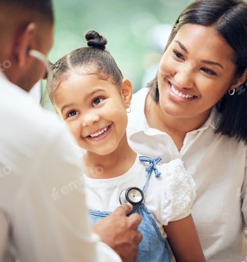 Preview: Male doctor examining happy little girl by stethoscope. Child sitting with mother while paediatrici
