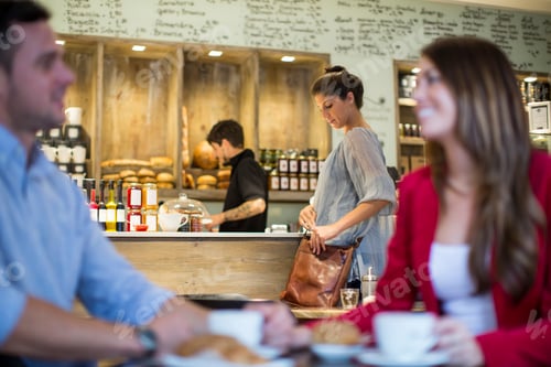 Preview: Couple talking in busy cafe