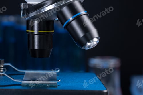 Preview: Microscope with lenses close up against dark background