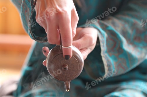 Preview: Teapot Being Poured with Elegant Teal Outfit