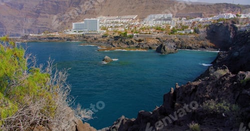Preview: Unrecognizable people enjoying a natural pool in the Atlantic Ocean of Tenerife, Acantilados de Los