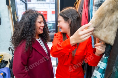 Preview: Women choosing clothes in a second hand store