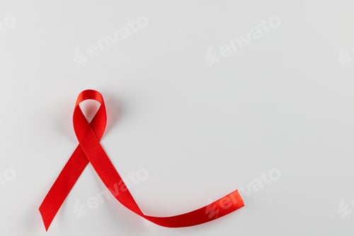 Preview: Composition of red ribbon for hiv or aids awareness, on white background with copy space