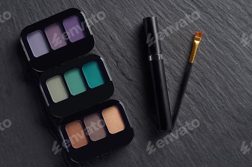 Preview: Makeup palettes with mascara and brush on dark slate background