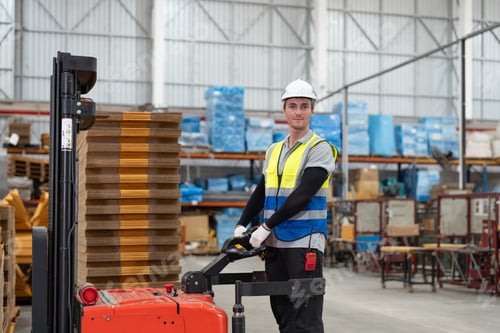 Preview: Man worker driver using forklift electric moving cardboard boxes sheet goods in paper box factory