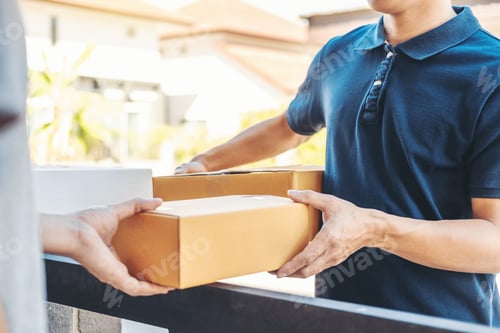 Preview: Delivery concept Asian Man hand accepting a delivery boxes from professional deliveryman at home