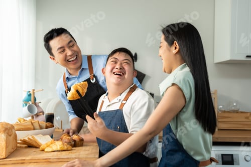 Preview: Asian happy family, mature parents baking bakery with son in kitchen.