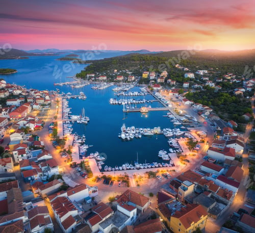 Preview: Aerial view of boats and yachts in port and city at sunset