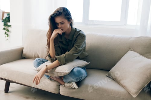 Preview: Woman with Long Hair Sitting on Couch