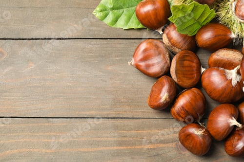 Preview: Fresh sweet edible chestnuts on wooden table, flat lay. Space for text