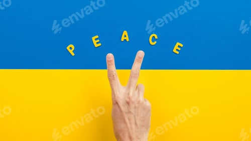 Preview: Victory and peace with hand making symbol on the flag of Ukraine
