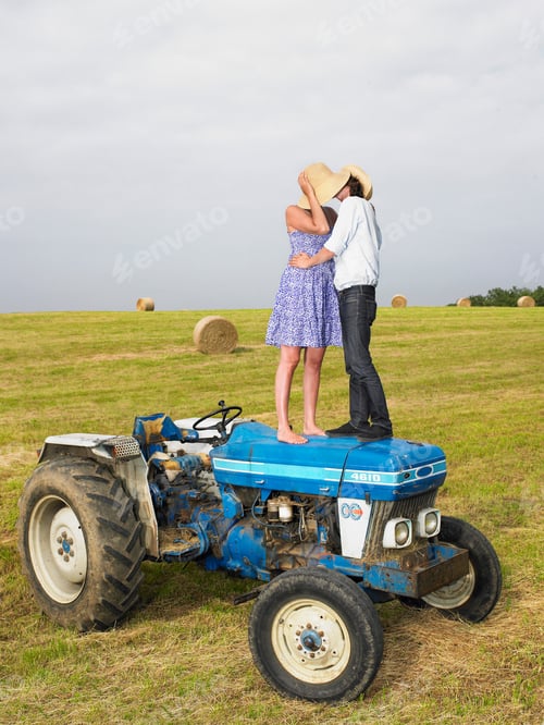 Preview: Couple kissing on top of tractor