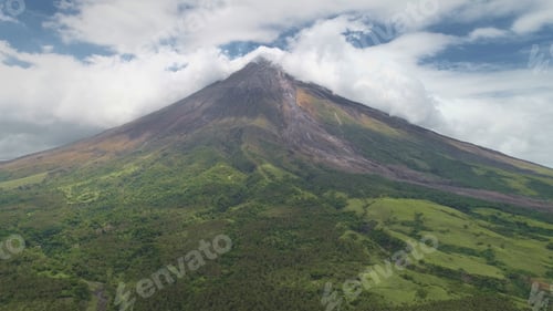 Preview: Aerial of Philippines volcano peak eruption clouds haze. Hiking path at hillside green grass valley