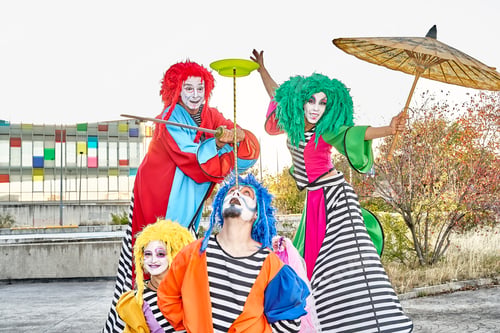 Preview: Excited clowns performing various tricks during festive event in park