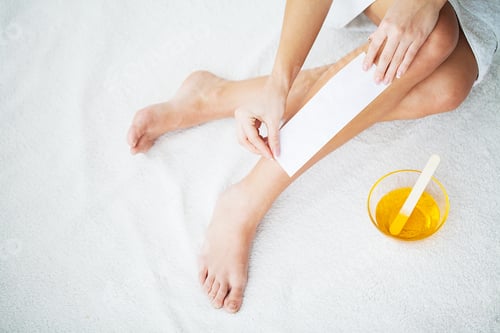 Preview: Waxing. Young Woman Depilating Her Leg With Wax Stripe